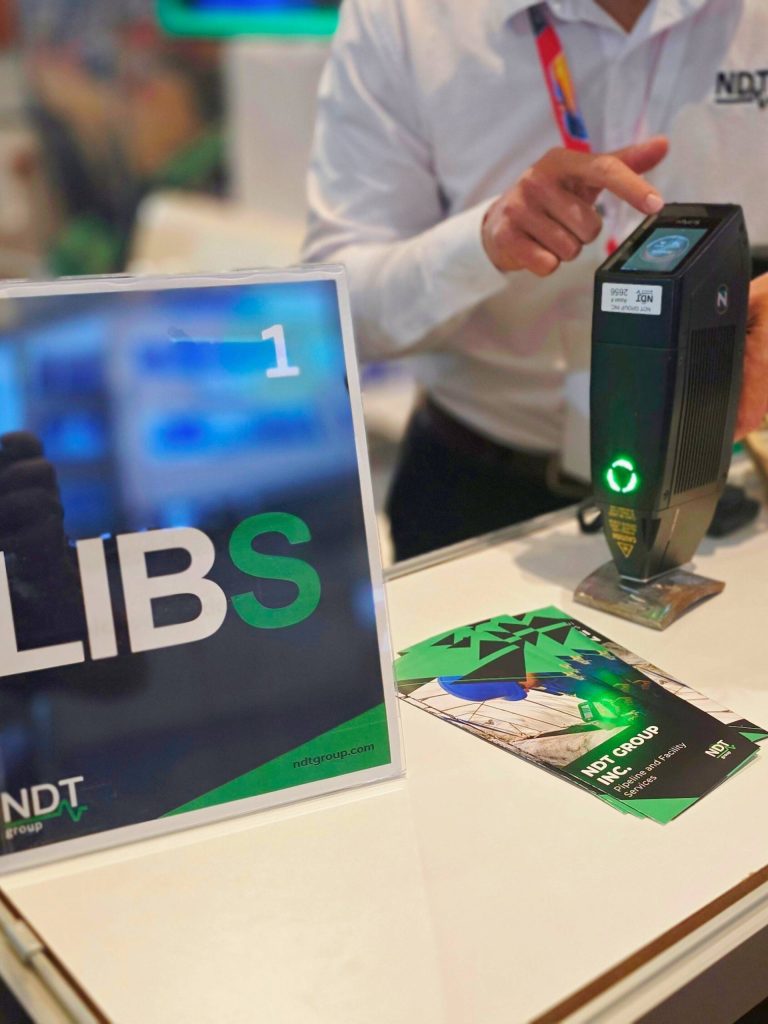 Engineer demonstrating LIBS material analysis to attendees.